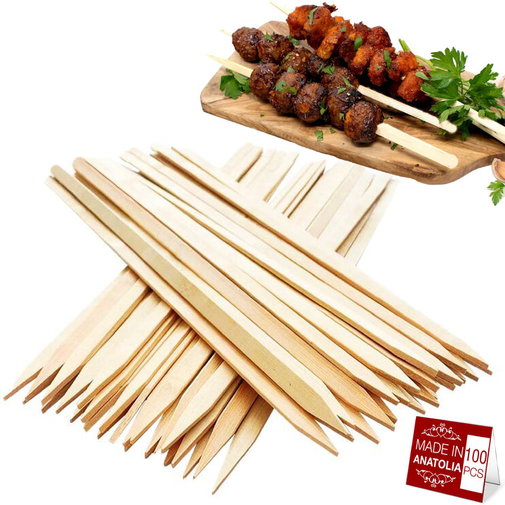 In the foreground, a pile of HAKAN 9.8-inch wooden skewers is displayed. In the background, two grill skewers with grilled meat and parsley rest on a wooden board. A red label reads Made in Anatolia, Hakan 100-Pack, perfect for your next BBQ adventure!.